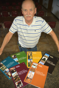 Dr. Steve amosson, Texas A&MAgriLife Extension Service economist, shows off the six new publications outlining agriculture use of the Ogallala Aquifer in the Southern High Plains. (Texas A&M AgriLife Communications photo by Kay Ledbetter)