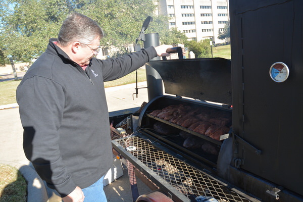 Dr. Davey Griffin, Texas A&M AgriLife Extension Service meat specialist, cooks beef sirloin, beef strip loin and pork loin. (Texas A&M AgriLife Extension Service photo by Blair Fannin)