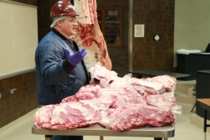 Dr. Davey, Griffin, Texas A&M AgriLife Extension Service meats specialist, discusses beef cuts at the barbecue town hall meeting. (Texas A&M AgriLife Research photo by Dr. Jeff Savell)