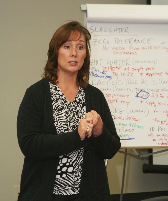A woman, Kerri Gehring, standing in front of a chart in a speaking pose