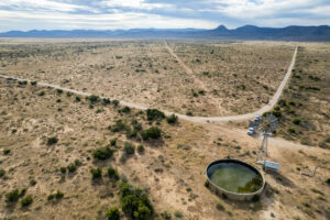 An aerial view of a West Texas ranch with a well.