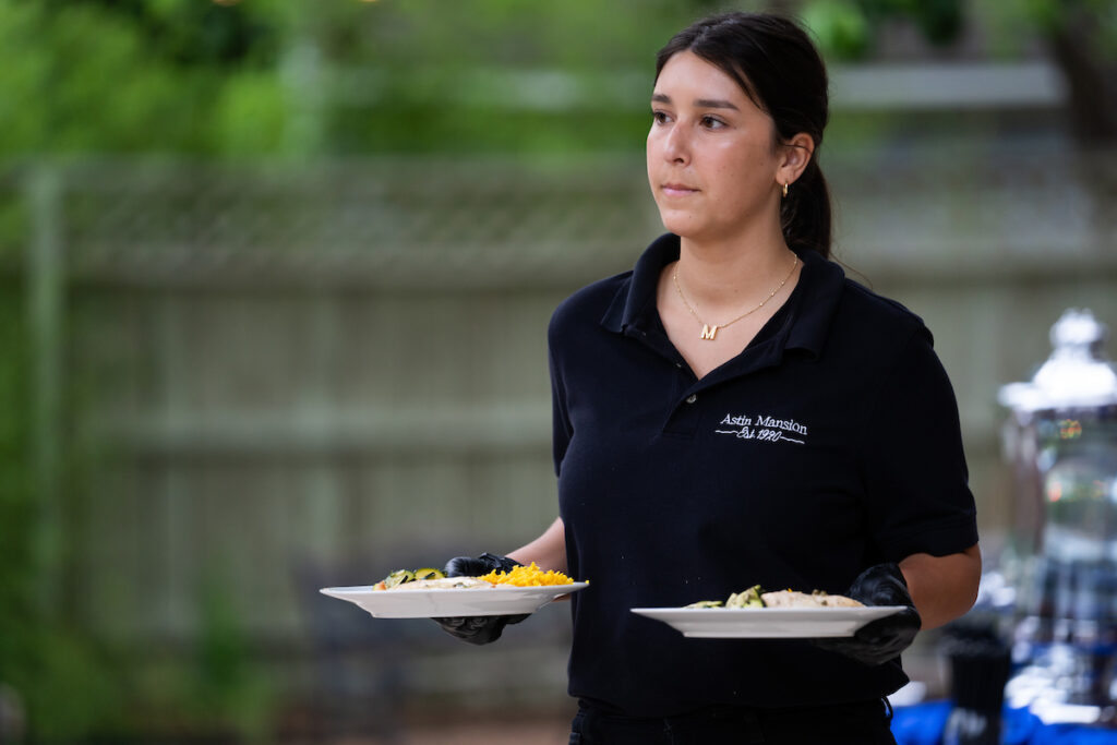 A woman is serving food at a banquet. Professional food managers will learn how to prevent foodborne illnesses, safe food handling practices, and prepare for the ServSafe certification exam during a food manager certification course on June 17 and 24 in Waco. (Katie Perkins/Texas A&M AgriLife)