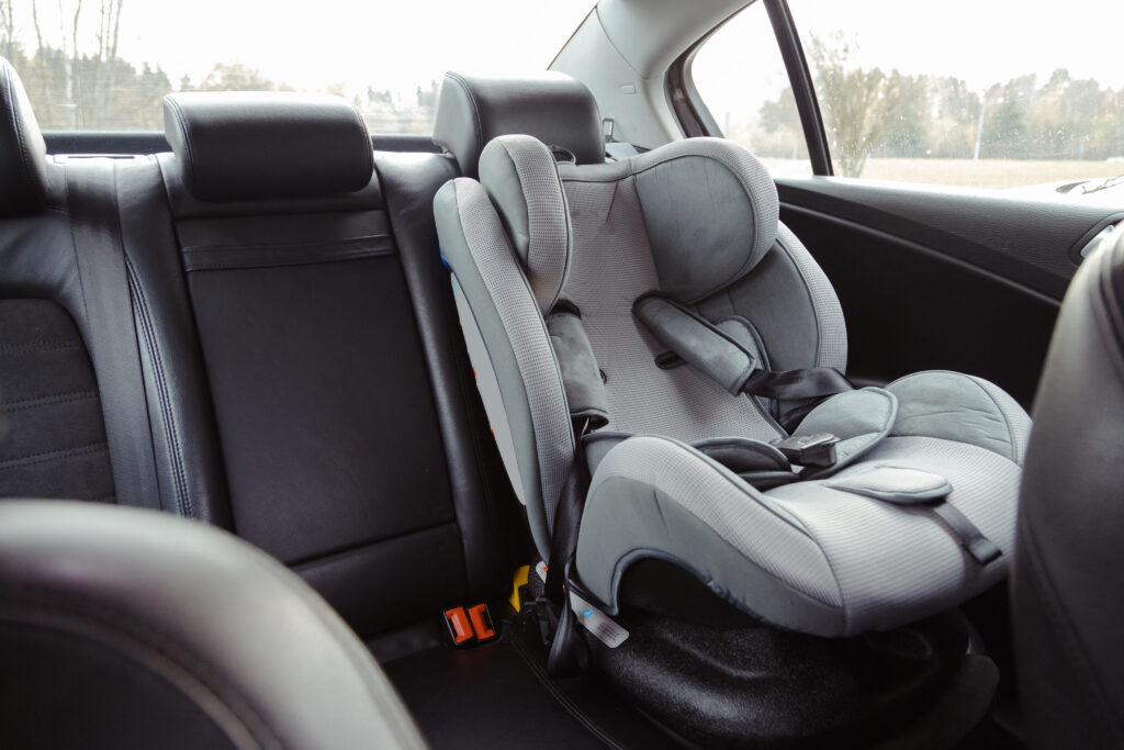 An empty child seat in the back of a vehicle.