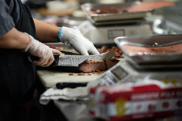 A person slicing brisket