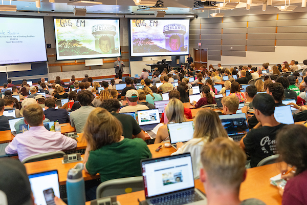 A classroom full of students watching a presentation