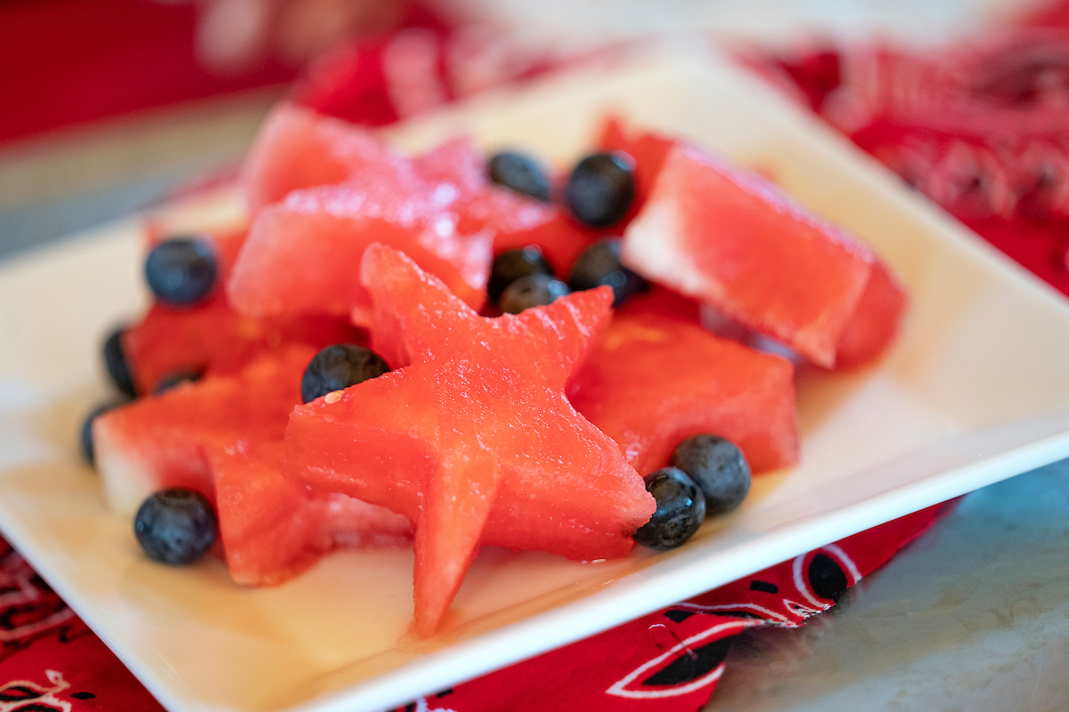 Watermelon cut in the shape of stars on a plate with blueberries