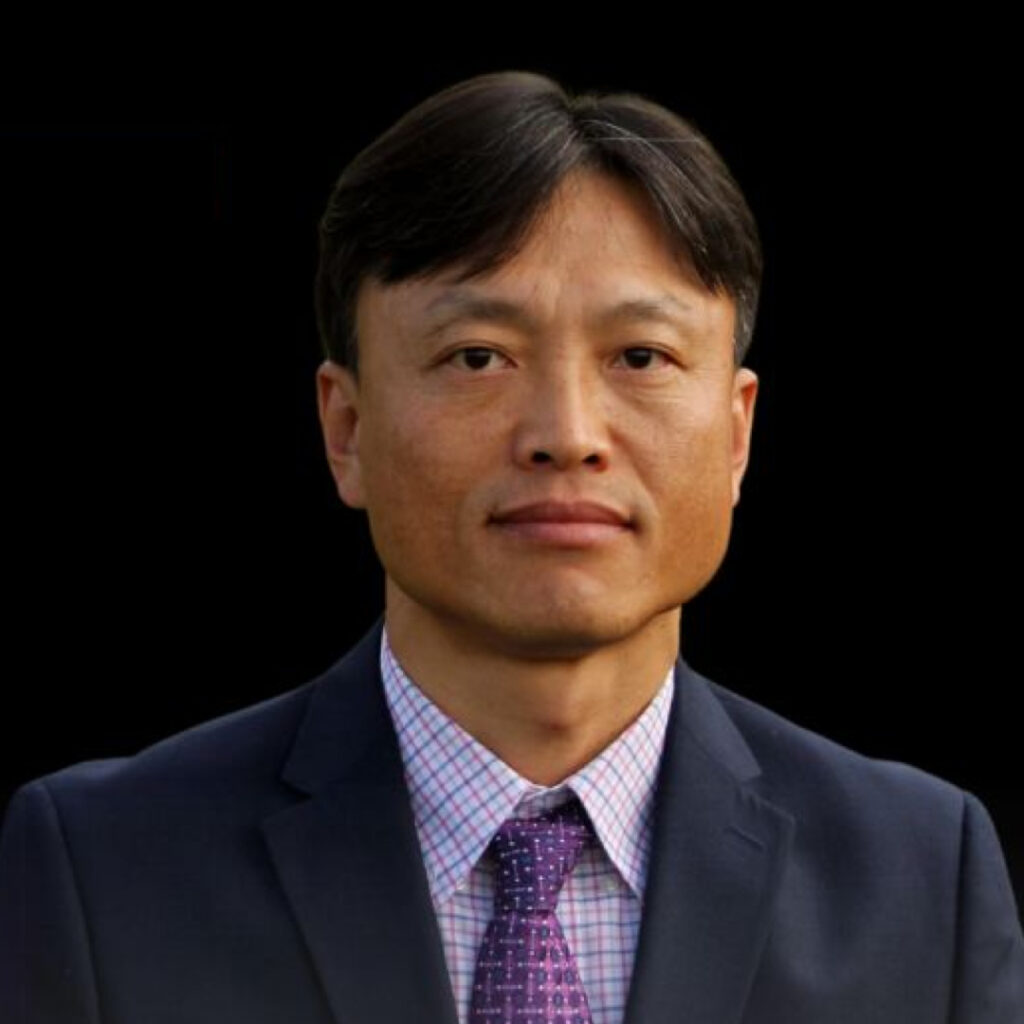 Man in suit and tie from the shoulders up with stoic expression