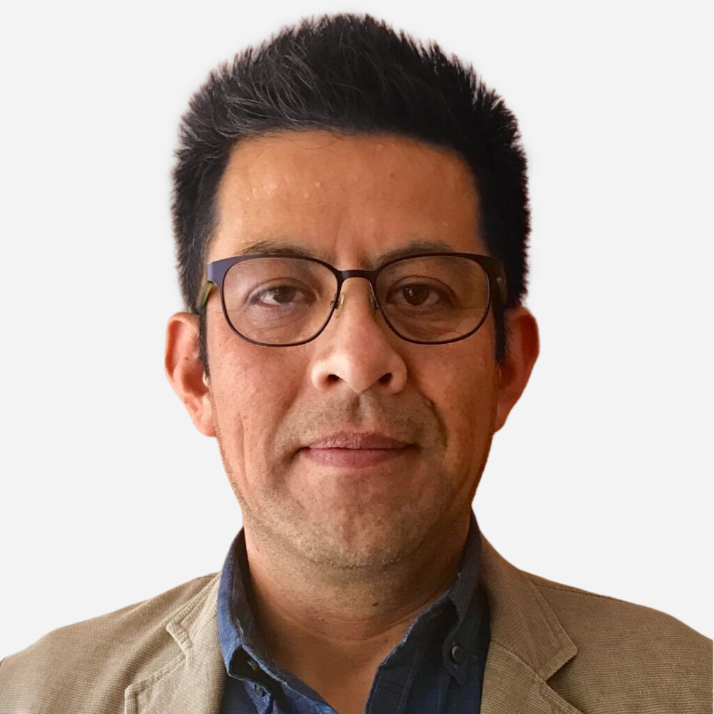 Man in a jacket and collared shirt from the shoulders up with stoic expression