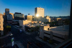 The El Paso skyline with the son reflecting off a building.