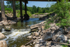 A creek flowing under a bridge