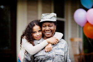 A young girl hugging a female soldier