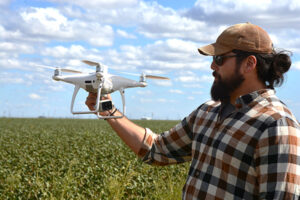 man holding a white drone